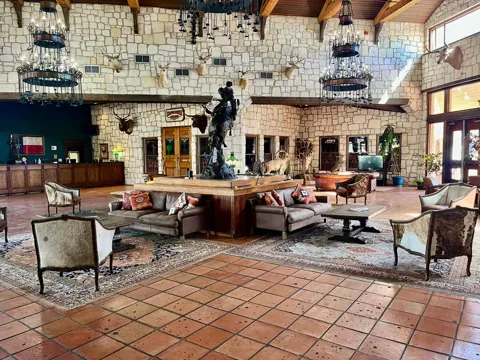 Hotel interior with stone walls and warm wood furnishings