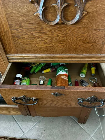An open drawer of household items during arranging