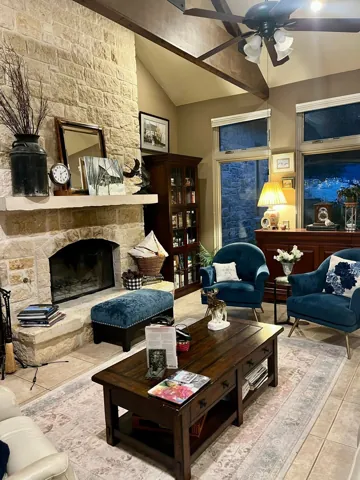 A stone fireplace and comfortable living room seating