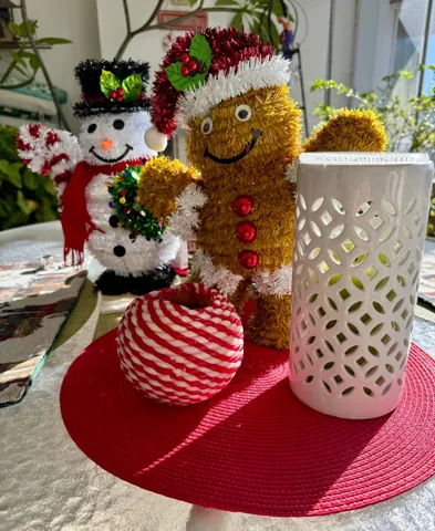 Gingerbread holiday decoration beside seasonal greenery