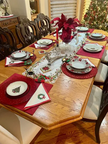 A dining table set with red holiday accents