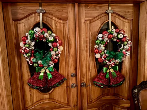 Holiday wreaths on a pair of wood doors