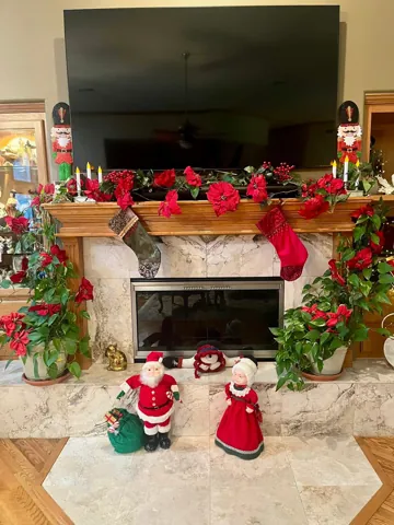 A decorated mantel with red Christmas stockings