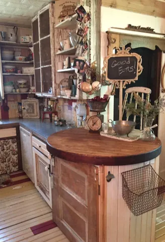 A wood kitchen island with a decorative chalkboard and hanging accents