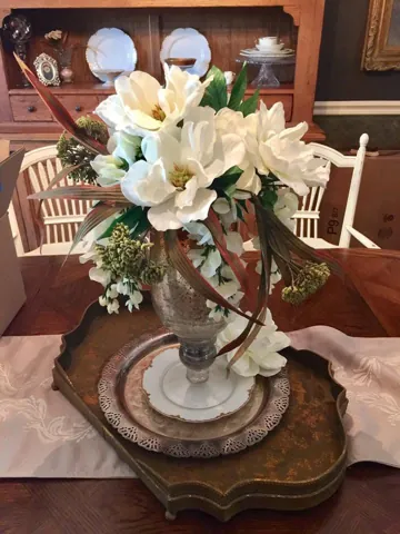A floral centerpiece on a wood dining table